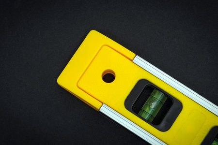 Yellow building level on a black background is used in constructionの写真素材