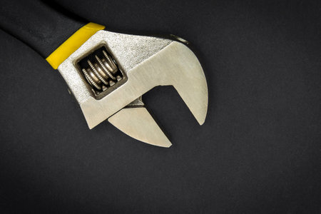 Adjustable wrench on dark background. Plumbing repair ideaの写真素材