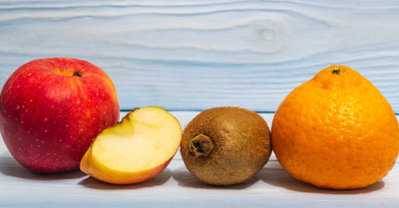 Set of fruits on a wooden blue background for composing diet and supply of vitaminsの写真素材