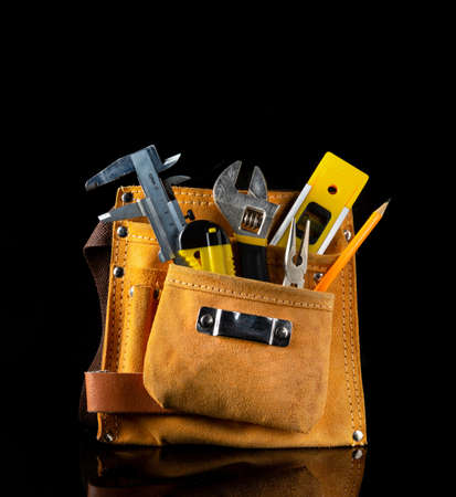 Tool kit in suede bag for plumber or construction craftsman on black isolated backgroundの写真素材