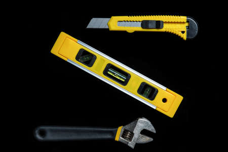 Tools for master builder on a black background. Close-up of construction tool. Top viewの写真素材