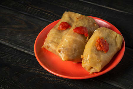 Three cabbage rolls with beef, rice and vegetables on the plate. Stuffed cabbage leaves with meat....