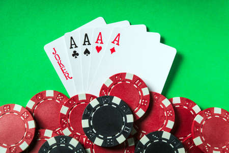 Poker game with five of a kind combination. Chips and cards on the green table. Successful win
