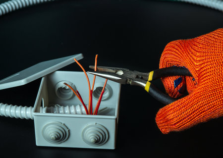 Short circuit in the mains. The hands of a master electrician close up or check during equipment repair.の写真素材