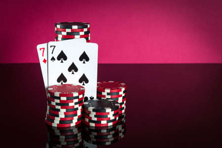 Poker cards with one pair combination. Close-up of playing cards and chips in poker club. Free...