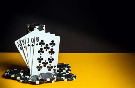 Poker cards with royal flush combination. Close-up of playing cards and chips in poker club. Free...