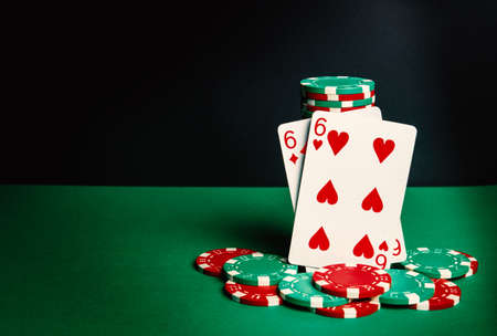 Poker cards with one pair combination. Close-up of playing cards and chips in poker club. Free...