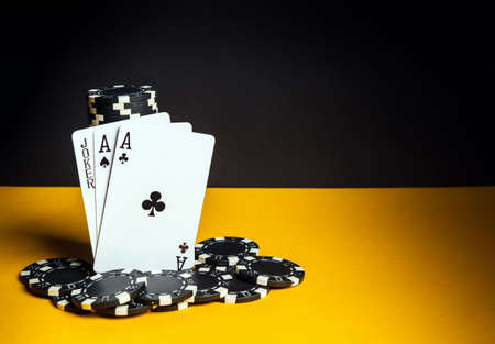 Poker cards with three of a kind or set combination. Close-up of playing cards and chips in poker club. Free advertising spaceの写真素材