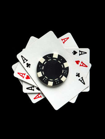 Successful and maximum win. Poker game with four of kind combination. Chips and cards on the black...