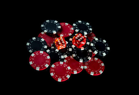 Poker dice and chips on black background. Craps club game concept. Poker gameの写真素材