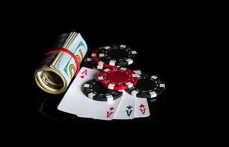 Three of a kind or set cards combination and dollars and chips. Winning combination at a poker club or casinoの写真素材