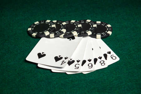 Poker game with straight combination. Chips and cards on green table. Successful and win four sevens