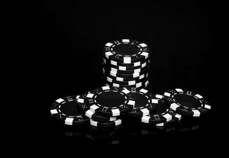 A stack of chips obtained as a result of winning on the black table. Successful casino poker game.の写真素材