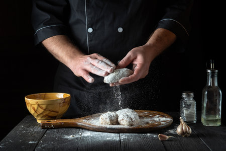 Professional chef prepares cutlets before frying in the restaurant kitchen. The idea of making a...