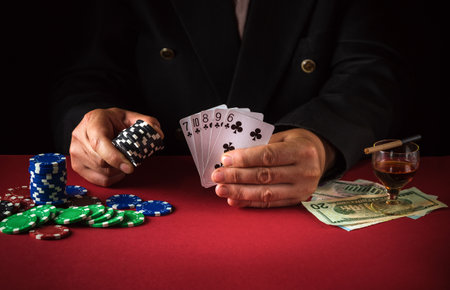 The player holds playing cards with a straight flush winning combination. Lucky win in a poker club...