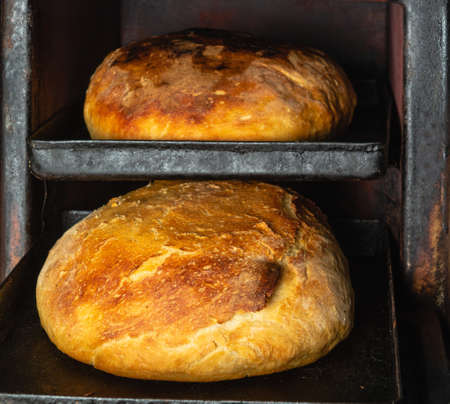Close-up of fresh artisanal bread baked in the oven in cooking and eating concept. homemade baking.の写真素材