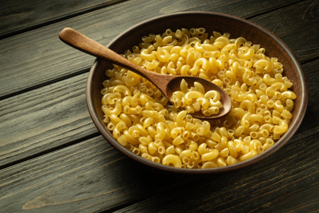 A full plate of raw pasta and a spoon on a vintage table before preparing breakfast. Place for...