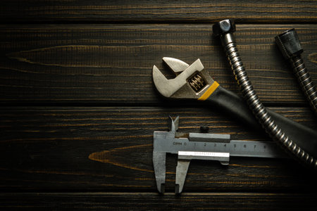 Master plumber tools and hose on black vintage table. Free space for advertising.の写真素材