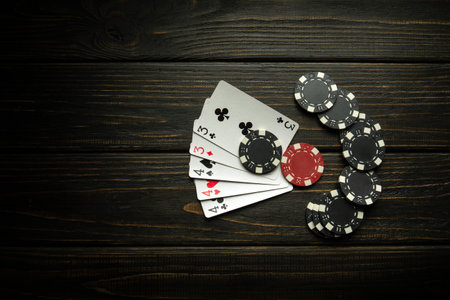 Gambling playing poker with a winning combination of full house or full boat. Cards with chips on a black vintage table in a poker club.の写真素材