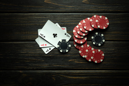 Playing cards with a winning combination of three aces. Luck in the game of poker depends on...