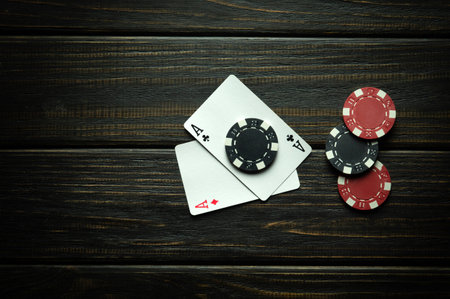 Playing cards with a winning combination of two aces. Luck in the game of poker depends on fortune. Advertising space on a black background.の写真素材