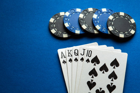 A popular and exciting poker game with a winning combination of royal flush. Playing cards and chips...