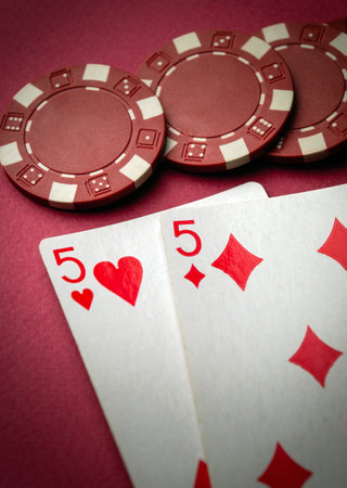 Successful win with playing combination cards one pair. Game in a poker club on a red table.
