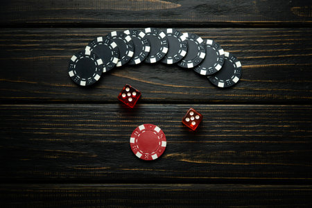 Dice and winning chips on a dark vintage table in a club. Successful combination in dice of two fives.の写真素材