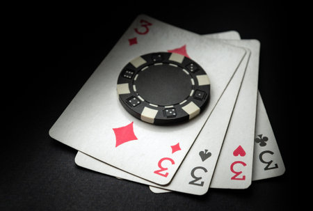 Lucky win with four playing cards. Poker game with a winning combination of four of a kind or quads.