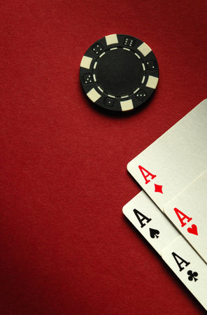 Card winning with a combination of aces four of a kind or quads on a red table in a poker club. Free...