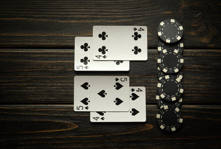 A combination of two pairs of poker cards - winning chips when playing in a club on a black vintage...