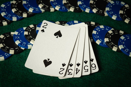 Playing cards layout on chips with a successful straight flush combination. Concept of winning a...