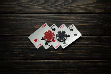 Playing cards and winning black and red chips on a vintage casino table. Concept of a successful...