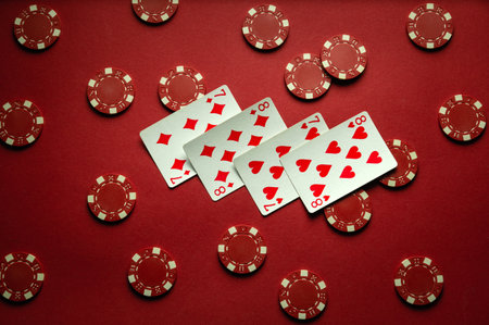 On the table in the club there are red chips and playing cards with a lucky combination of two...