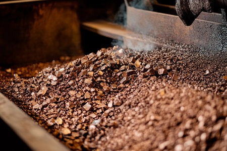 In a warm, inviting workshop, freshly roasted coffee beans glisten under soft lighting.の素材