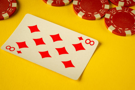 Bright yellow background features a card displaying the number eight of diamonds alongside red poker...