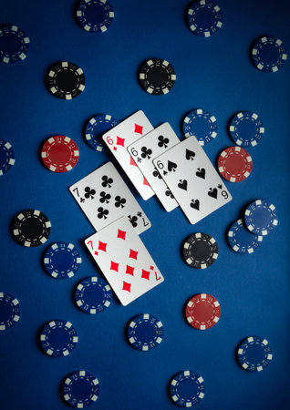 Players engage in a lively poker game, surrounded by colorful chips and cards, showcasing anticipation and excitement in a dimly lit setting.の写真素材