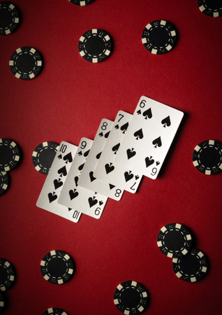 Five playing cards from the same suit are displayed, surrounded by black poker chips on a vibrant...