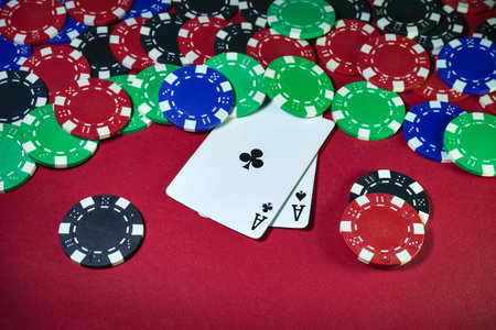 Players are engaged in a lively poker game featuring a mix of colored chips scattered across a red...