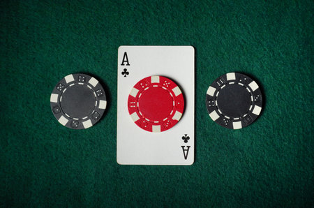 Poker chips and an Ace of clubs card are arranged on a green felt table. The scene captures the...