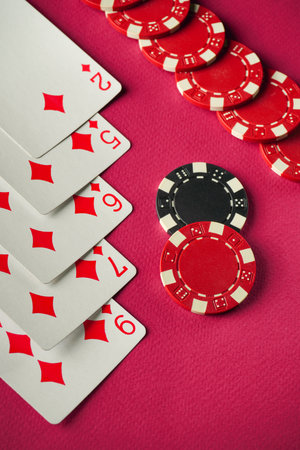 A straight poker hand that rewards a lot of winning chips. Concept of a card game played on a red...