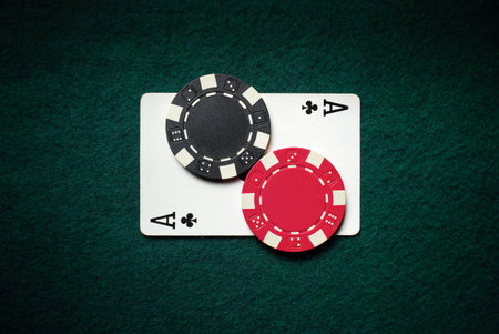 An ace of diamonds and two black and red chips in the casino on the table. This is a symbol of luck...