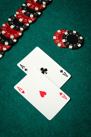 Poker gambling concept. A modest winning combination of one pair playing cards on the table and...