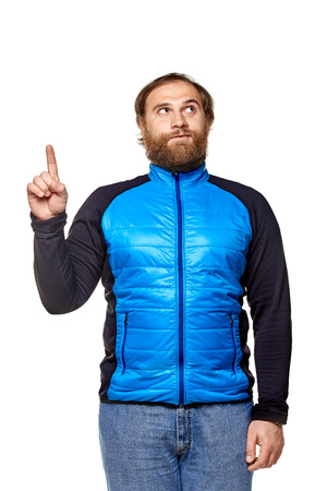 stoutman  wearing jeans and blue sweater, shows forefinger, looking into the top corner, isolated on a white backgroundの写真素材