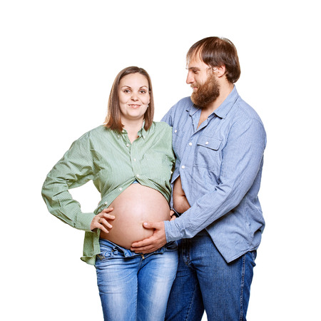 stout man with tummy and pregnant woman on a white background, isolated on a white backgroundの写真素材