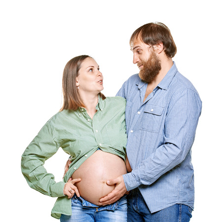 stout man with tummy and pregnant woman on a white background, isolated on a white backgroundの写真素材