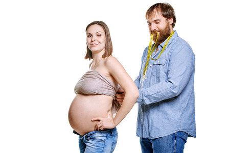 stout man with measure tape and pregnant woman on a white background, isolated on a white backgroundの写真素材