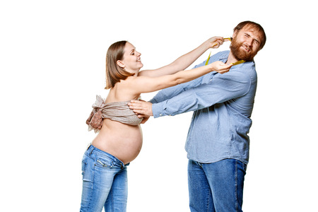 stout man with measure tape and pregnant woman on a white background, isolated on a white backgroundの写真素材
