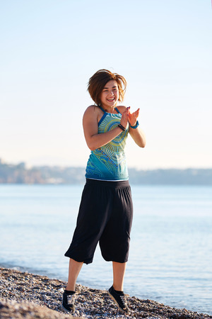 girl plays on the sea beach at the early morningの写真素材