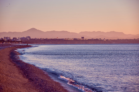 beach with wave and pebbles at the sunrise. Antalya, Turkeyの写真素材
